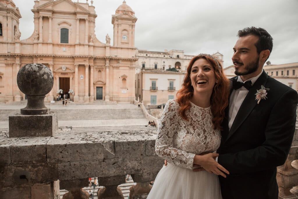 Couple in beautiful place in front of Noto's church